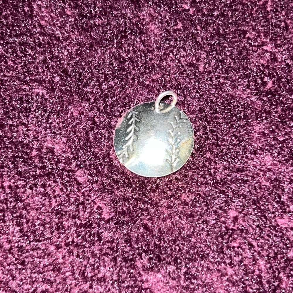 Silver softball pendant.